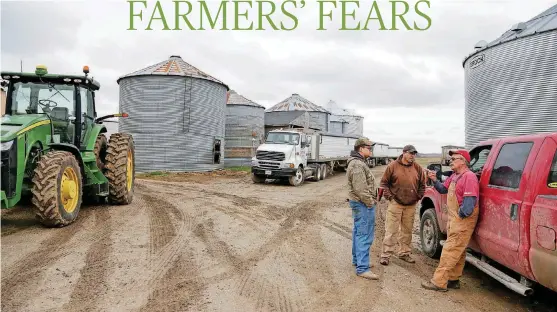  ??  ?? Blake Hurst, right, a corn and soybean farmer and president of the Missouri Farm Bureau talks with his son Dallas Hurstand his brother Brooks Hurst on his farm in Westboro, Mo.
[AP PHOTOS]