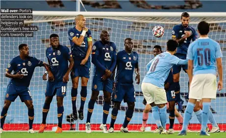  ?? PICTURE: AP ?? Wall over: Porto’s defenders look on helplessly as Gundogan’s free-kick curls towards goal