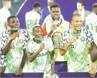  ??  ?? Super Eagles players, (L) John Ogu, Henry Onyekuru, Francis Uzoho (back) and William Troost-Ekong celebrate after their victory over Tunisia in the third place match at the 2019 AFCON in Egypt