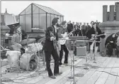  ?? WALT DISNEY STUDIOS VIA GETTY IMAGES ?? The Beatles perform in public for the last time in 1969 on this London rooftop.