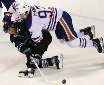  ?? EZRA SHAW/GETTY IMAGES ?? Connor McDavid, here checking fellow captain Joe Pavelski last month, makes his playoff debut Wednesday.