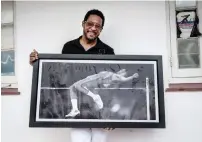  ?? AFP ?? Cuban former high jumper Javier sotomayor poses with a picture of himself during an interview in havana. —
