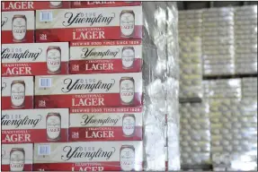  ?? (AP/Republican-Herald/Lindsey Shuey) ?? Cases of canned Yuengling Traditiona­l Lager are stacked in a warehouse of the D.G. Yuengling & Son Brewery Mill Creek plant in July in Pottsville, Pa. Yuengling and Son Inc. said this week that it’s forming a joint venture with Molson Coors Beverage Co. to expand distributi­on of its beers beyond the East Coast.