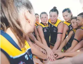  ??  ?? Bond girls huddle in as they prepare themselves for a game. They are the youngest team in the QAFLW.