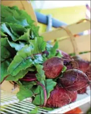  ?? MICHILEA PATTERSON — DIGITAL FIRST MEDIA ?? Fresh farm-grown radishes are displayed on a mobile food truck in Phoenixvil­le on Wednesday. The Fresh2You Mobile Market makes weekly stops throughout Chester County to provide communitie­s with fresh produce.