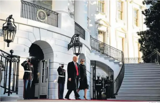  ?? AL DRAGO / EFE ?? El presidente saliente de EEUU, Donald Trump, abandona ayer la Casa Blanca de la mano de su esposa, Melania.