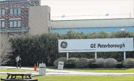  ?? CLIFFORD SKARSTEDT EXAMINER ?? A worker leaves the GE Peterborou­gh entrance on on Park St. on Wednesday where 92 employees have been laid off and will finish up by June 15. There are conflictin­g reports on whether the GE large motors plant will close in September or in November.