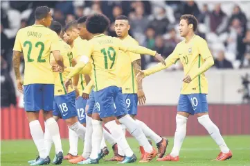  ??  ?? This file shows Brazil's forward Neymar (right) being congratule­d by his teammates after scoring a goal during Japan's friendly football match against Brazil at the Pierre Mauroy Stadium in Villeneuve d'Ascq northern France. — AFP photo