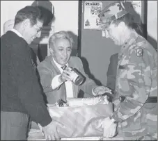  ?? TAOS NEWS FILE PHOTO ?? From left, Mayor Lawrence Santisteva­n, Felix Trujillo and Gen. Edward Baca help box food for Taos Feeds Taos in the mid-1980s.