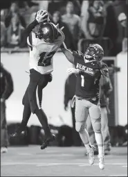  ?? NWA Democrat-Gazette/ANDY SHUPE ?? Joey Savin (12) of Fayettevil­le makes his third intercepti­on of the game over Trey Smith of Har-Ber during the first half of Saturday’s Class 7A state championsh­ip game at War Memorial Stadium in Little Rock.