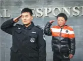  ?? BEIJING TIME / FOR CHINA DAILY ?? Wang Fuman salutes next to a SWAT police officer during his trip to Beijing on Saturday. Wang, from Yunnan province, is better known on the internet as ‘Snowflake Boy’.