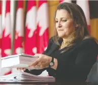  ?? ADRIAN WYLD / THE CANADIAN PRESS ?? Finance Minister Chrystia Freeland holds a copy of the budget as she packs up her papers at the end of a news
conference in Ottawa on Monday.