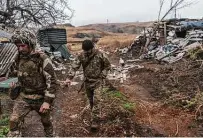 ?? Brendan Hoffman / New York Times ?? Ukrainian soldiers patrol along the Kalmius River. The U.S. says Russia has moved 70,000 troops to Ukraine’s borders.