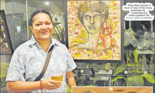  ?? Picture: JONA LALAKOBAU ?? Tavai Bale stands in front of one of the many paintings by contempora­ry artist Lambert Ho.