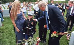  ?? EVAN VUCCI, AP ?? Brittany Jacobs watches as her 6-year-old son, Christian, talks with President Trump at Arlington National Cemetery on May 29. Jacob’s father was killed in 2011.