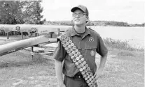  ?? LUIS SANTANA/TAMPA BAY TIMES ?? Ron Cain — the first Boy Scout in the Tampa Bay area to earn all Boy Scout merit badges — poses at the Flaming Arrow Scout Reservatio­n.