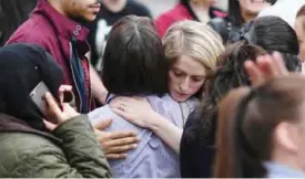  ??  ?? MANCHESTER: Retail staff hug each other after being evacuated from the Arndale Centre shopping mall in Manchester, northwest England yesterday following a security alert the day after a deadly terror attack at the Manchester Arena.