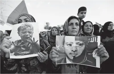  ??  ?? Syrian refugees protest the Turkish offensive against Syria during a demonstrat­ion at the Domiz refugee camp on the outskirts of Dohuk, Iraq, on Saturday. — Reuters