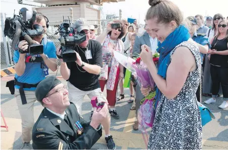  ?? CANADIAN ARMED FORCES ?? Cpl. Robert Basso, an HMCS Ottawa crew member, proposes to his girlfriend Kacie Sutton after returning from a five-month deployment in the Asia-Pacific on an exercise called Poseidon Cutlass 17, involving many countries.