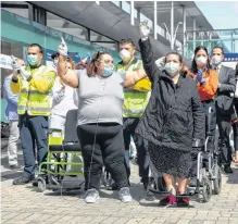  ?? REUTERS ?? Last patients Gloria, Maria and Patrocina wearing protective face masks react after being discharged from a temporary hospital set up at IFEMA fairground­s, before its closure, amid the coronaviru­s disease outbreak in Madrid, Spain on May 1.