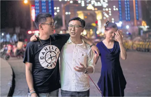  ??  ?? Duan Rongfeng, left, and Li Tao with Li Tao’s mother, He Fenglanm, in Shanghai.