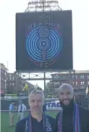  ?? THE COMMERCIAL APPEAL ?? Sporting director Andrew Bell and soccer legend Tim Howard pose for a photo at AutoZone Park, newly transforme­d into a soccer pitch, as they reveal the new Memphis 901 FC name and logo. KATHERINE BURGESS /