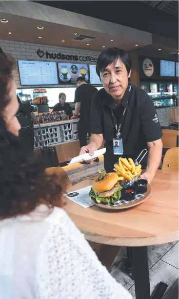  ?? Picture: STEWART McLEAN ?? FRESH FLAVOURS: Hudsons and The Crafty Cassowary Kitchen and Bar supervisor Pauline TanWasley serves up a meal in the new cafe.