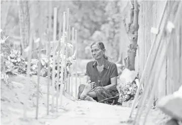  ??  ?? A woman is seen during mass burials near St. Sebastian church in Negombo. — Reuters photo