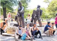  ?? JILL KNIGHT/RALEIGH NEWS OBSERVER ?? A crowd of people catch virtual Pokémon using the Pokémon Go phone applicatio­n in Nash Square in Raleigh, N.C.