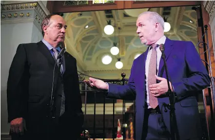  ?? — THE CANADIAN PRESS ?? B.C. Green party Leader Andrew Weaver, left, and B.C. NDP Leader John Horgan play to the media at the legislatur­e in Victoria on Monday after announcing their political deal.