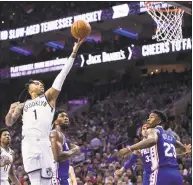  ?? Chris Szagola / Associated Press ?? The Nets’ D’Angelo Russell, left, goes up for the shot as he gets past the 76ers’ Joel Embiid, center during Saturday’s Game 1 of a first-round playoff series.