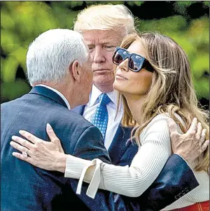  ?? AP/ANDREW HARNIK ?? President Donald Trump and first lady Melania Trump say goodbye to Vice President Mike Pence on Friday at the White House before boarding the helicopter Marine One.