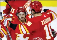  ?? JEFF MCINTOSH — THE ASSOCIATED PRESS ?? Calgary Flames’ Johnny Gaudreau, left, and Nikita Zadorov celebrates defeating the Dallas Stars in overtime in Game 7of their first-round NHL playoff series. Gaudreau scored the winning goal in a 3-2 win.