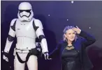  ??  ?? This file photo shows US actress Carrie Fisher (right) posing with a storm trooper as she attends the opening of the European Premiere of “Star Wars: The Force Awakens” in central London.