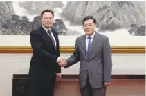  ?? MINISTRY OF FOREIGN AFFAIRS OF THE PEOPLE’S REPUBLIC OF CHINA VIA AP ?? China's Foreign Minister Qin Gang, right, poses for photos with Tesla Ltd. CEO Elon Musk on Tuesday in Beijing.