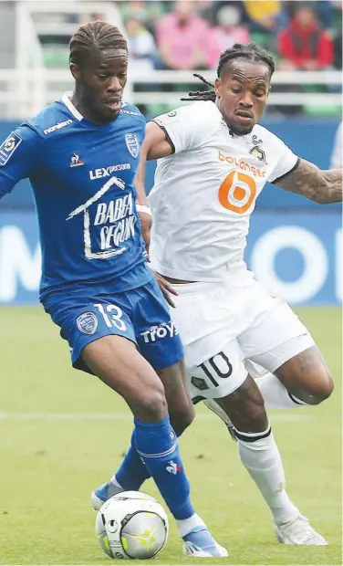  ?? Agence France-presse ?? Troyes’ Ike Ugbo (left) fights for the ball with Lille’s junior Luz Sanches during their French League match on Sunday.