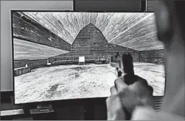  ?? JOHN LOCHER/AP ?? A gambling game prototype by G2 Game Design was demonstrat­ed in Las Vegas recently. Players use a gun to shoot much like a video game, but betting is allowed.