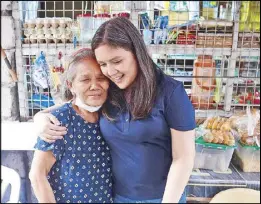  ?? ?? Las Piñas Rep. Camille Villar meets with Librada Romero, a street sweeper who was able to open a sari-sari store under the Pasa-Tulong program.