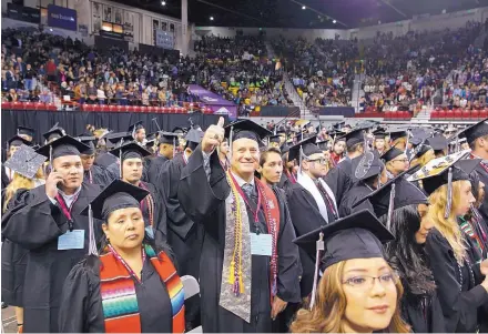  ?? ANDRES LEIGHTON/NMSU ?? NMSU graduate Wade Loosbrock gives a thumbs up to his relatives during the 2016 Fall Commenceme­nt at the Pan American Center.