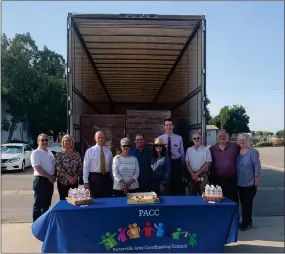  ?? RECORDER PHOTO BY ESTHER AVILA ?? From left, Don Sowers, Qursha Clark, Kelley Ivancovich, Donna Grigsby, Ryan Land, Naomi Schuler, Allan Bailey, Bill Adkins, John Billiou and Brenda Billiou stand before the first of two truck loads of pallet donations filled with nonperisha­ble food items on Tuesday, Sept. 14, 2021. It was all part of the humanitari­an-aid arm of the Church of Jesus Christ of Latter-day Saints.