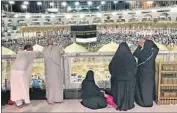  ??  ?? PEOPLE LOOK OVER the crowds at the Grand Mosque in Mecca during the five-day hajj pilgrimage.