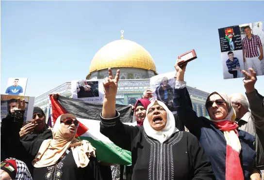  ??  ?? Families of Palestinia­ns imprisoned in Israeli jails protest Friday outside the Dome of the Rock at Al-Aqsa Mosque compound in Jerusalem’s Old City. (AFP)