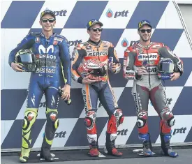  ??  ?? ABOVE Honda’s Marc Marquez, centre, poses with Yamaha’s Valentino Rossi, left, and Ducati’s Andrea Dovizioso after yesterday’s qualifying.