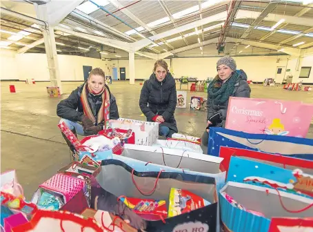  ??  ?? Volunteers Kate Hope, Hillary Haman and Charlotte Lever – concerned some youngsters may not get presents.