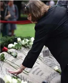  ?? HeRALD STAFF FILe ?? ‘RIPPLES OF HER PEBBLE’: Leslie Blair touches her sister Susan Blair’s name on the memorial in the 9/11 Contemplat­ive Garden during the 17th anniversar­y of the attacks of 9/11 on Sept. 11, 2018.