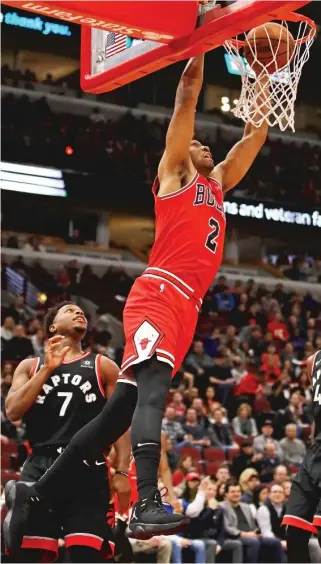  ?? GETTY IMAGES ?? Jabari Parker gets past Raptors guard Kyle Lowry and slams down two of his 12 points.