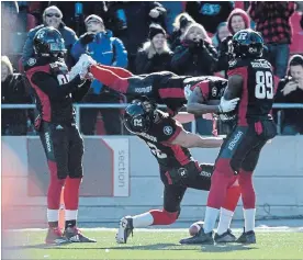  ?? CANADIAN PRESS FILE PHOTO ?? Ottawa Redblacks’ Juron Criner and Dominique Rhymes hold up Diontae Spencer after his TD as Greg Ellingson limbos underneath him in the 2017 CFL Eastern semifinal.