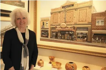  ?? ?? Artist Yvette Moore poses beside her painting about the old Capitol Theatre. Photo by Saddman Zaman