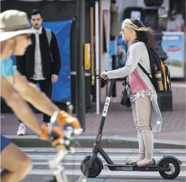  ?? DAVID PAUL MORRIS/BLOOMBERG ?? San Francisco’s policy-makers are pushing Bird, a startup based in Santa Monica, Calif., to rectify its practices with its electric scooters. Bird is among companies offering GPS-enabled scooters and bicycles that have spread across several major U.S....