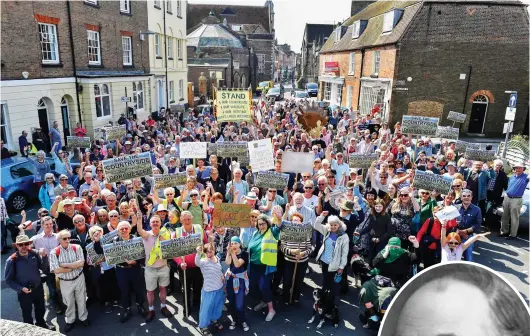  ??  ?? Fightback: Marchers gather to protest at the developmen­t outside Dorchester